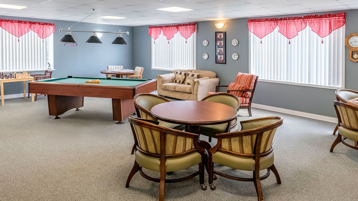 A cozy game room featuring a pool table and comfortable seating arrangements.