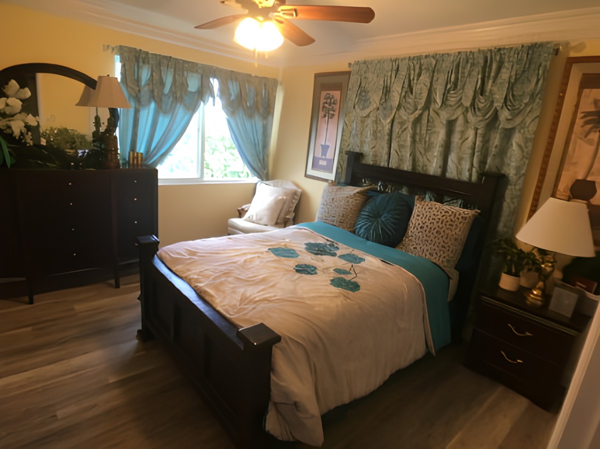 A cozy bedroom with elegant decor and a neatly made bed.