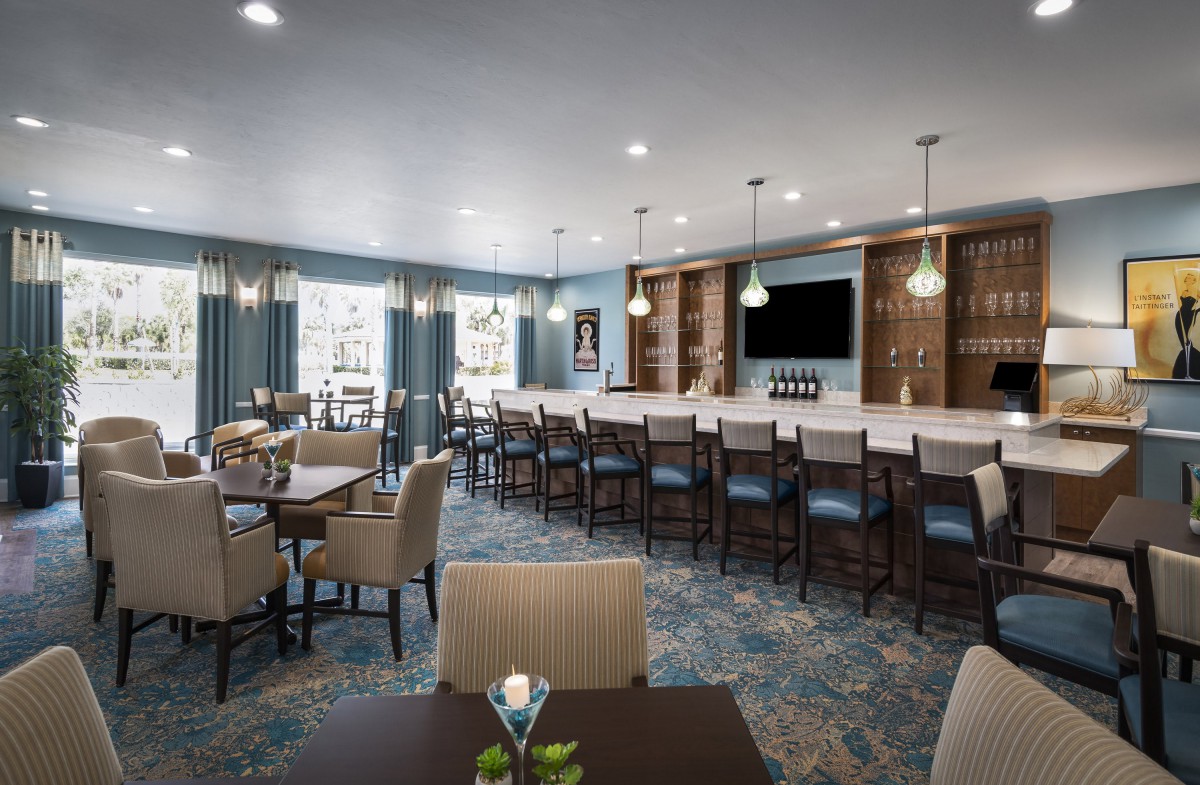 A modern bar and dining area with elegant seating and lighting.
