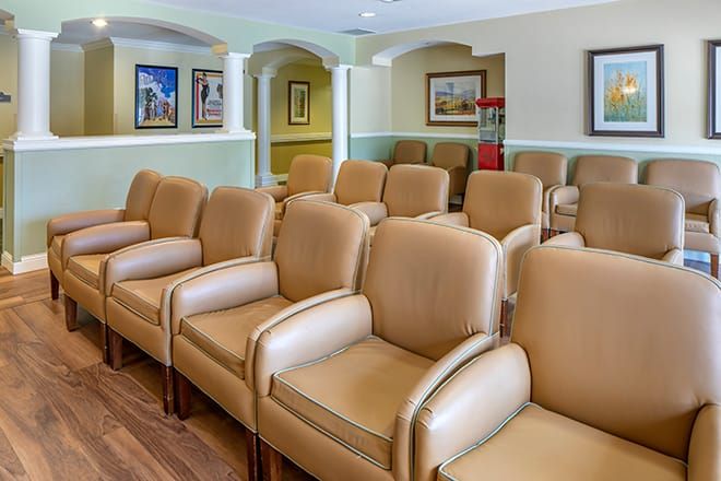 A spacious room with rows of comfortable chairs, likely used for viewing or meetings.