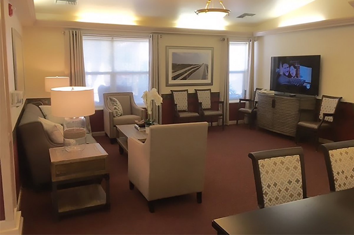 A cozy living room with contemporary furniture and a television.