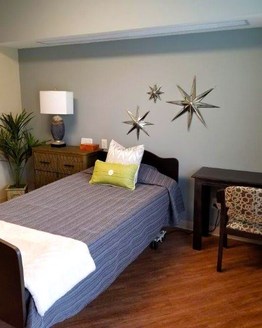 A cozy bedroom with a single bed, decorative wall art, and modern furnishings.