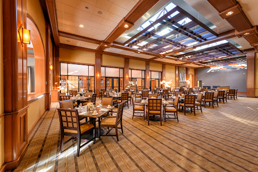 An elegant dining area featuring modern furnishings and warm lighting.