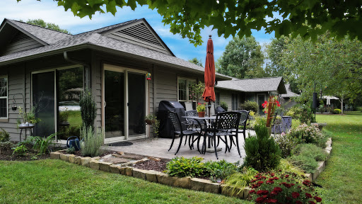 A cozy outdoor patio area perfect for relaxation, featuring stylish furniture and lush greenery.