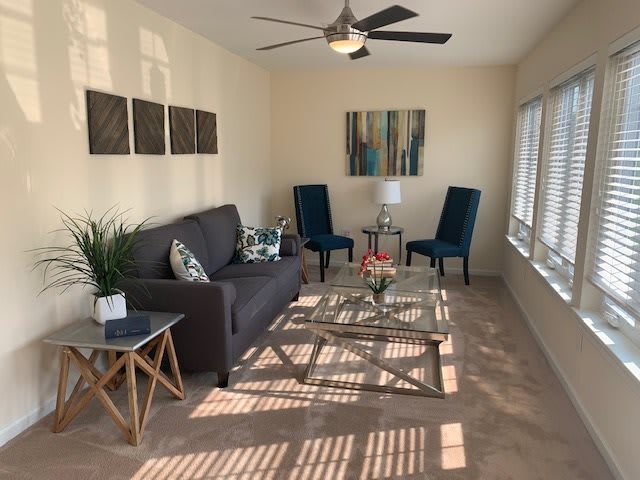 A modern living room featuring a comfortable sofa, stylish chairs, and elegant decor.