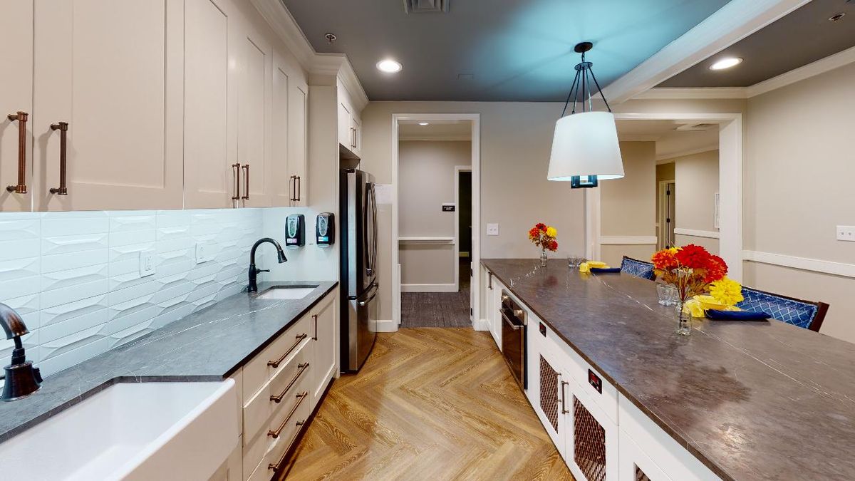 A modern kitchen featuring sleek cabinetry, stainless steel appliances, and elegant lighting.