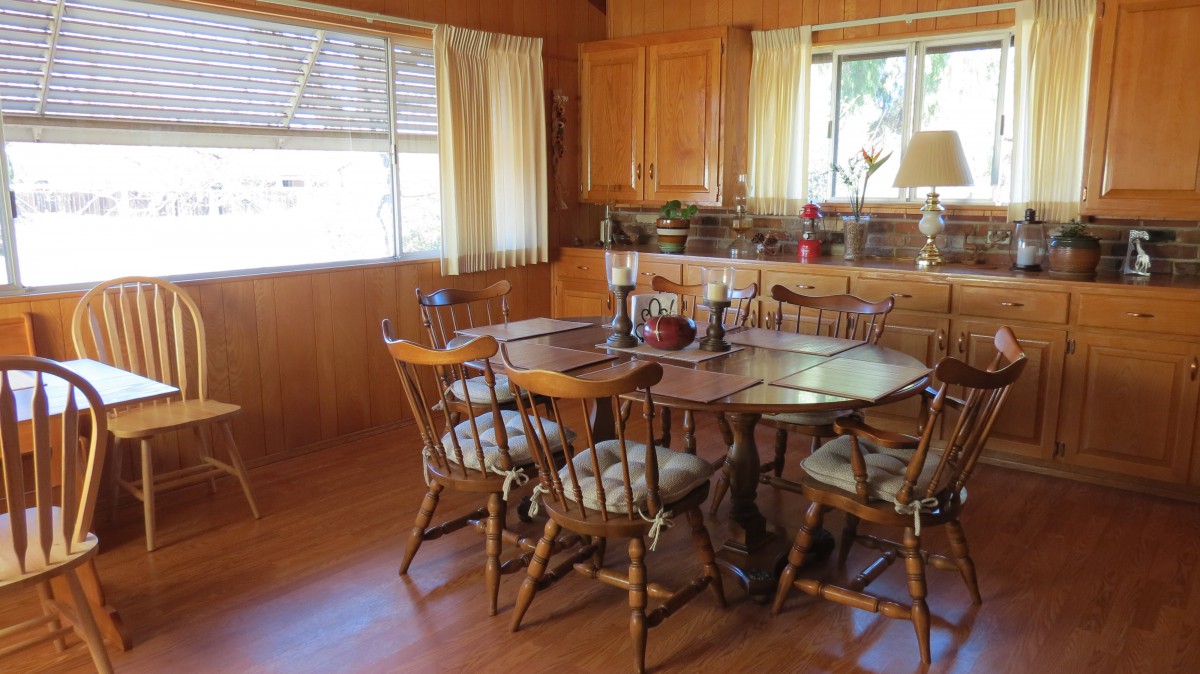 A cozy dining room with wooden furniture and soft lighting.