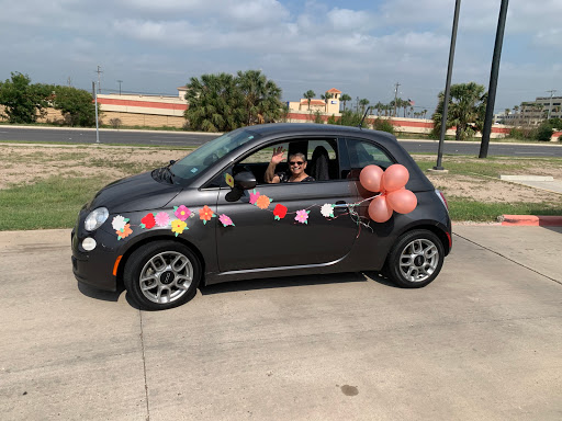 A cheerful, decorated car ready for a celebration with balloons and flowers.