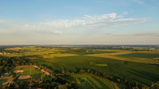 A picturesque view of expansive fields under a clear sky, showcasing the beauty of rural landscapes.