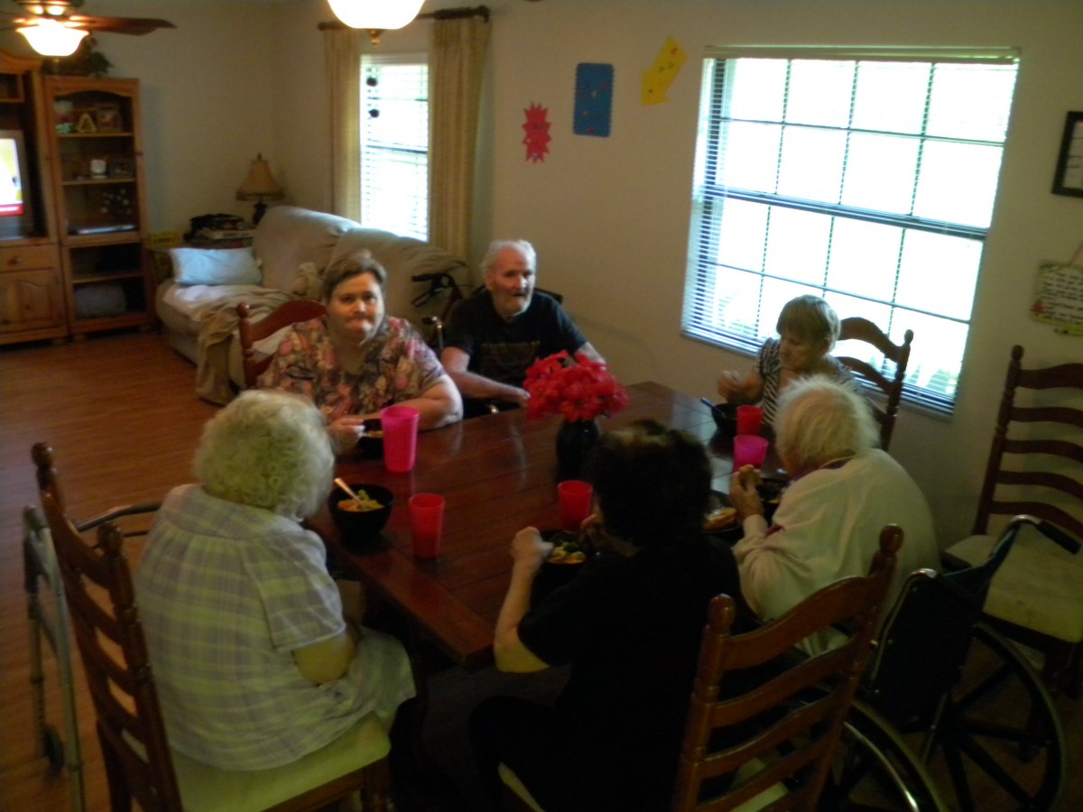 A group of seniors enjoying a meal together indoors.