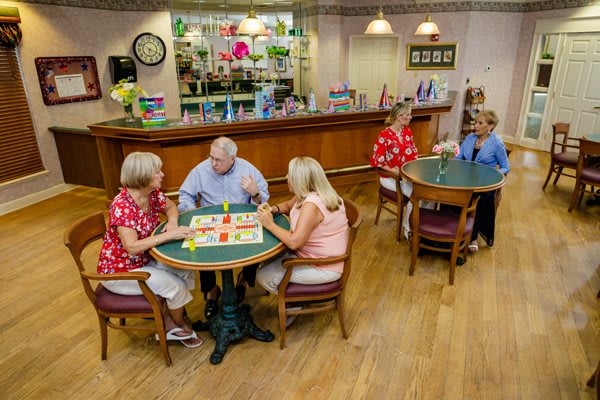 A group of seniors enjoying a game together in a cozy indoor setting.