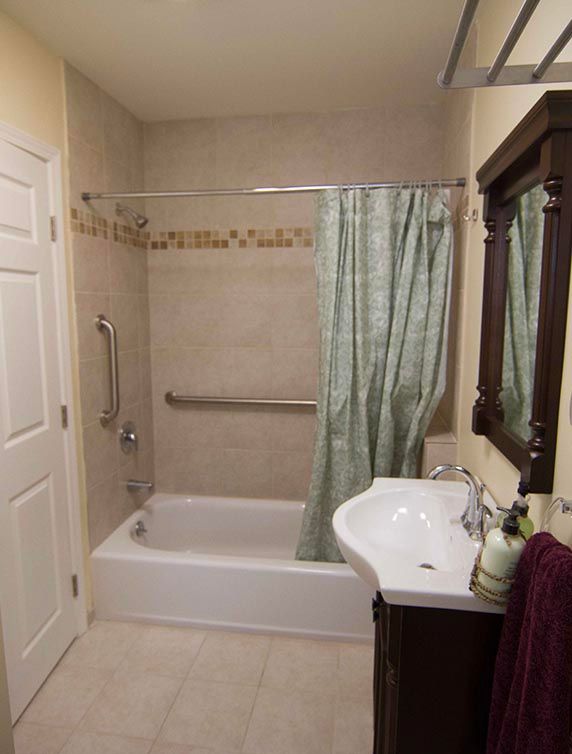 A well-organized bathroom with a bathtub, shower curtain, and sink.