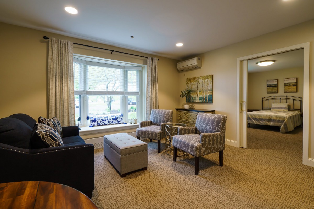A cozy living room with comfortable seating and large windows allowing natural light.