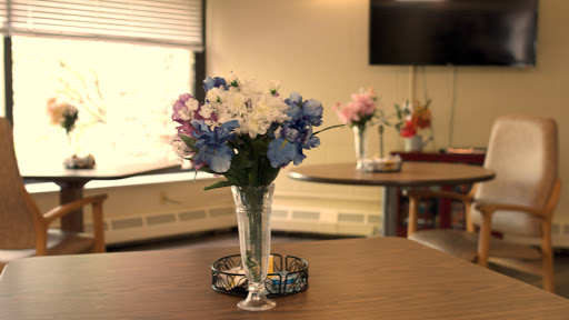A vibrant floral arrangement in a glass vase, adding a touch of color to the table.