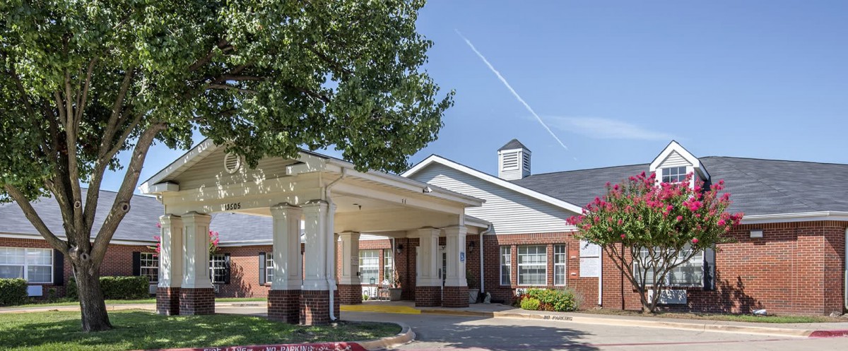 A view of the entrance to a residential building with well-maintained landscaping.