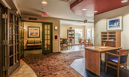 A cozy lobby with a reception desk and seating area.