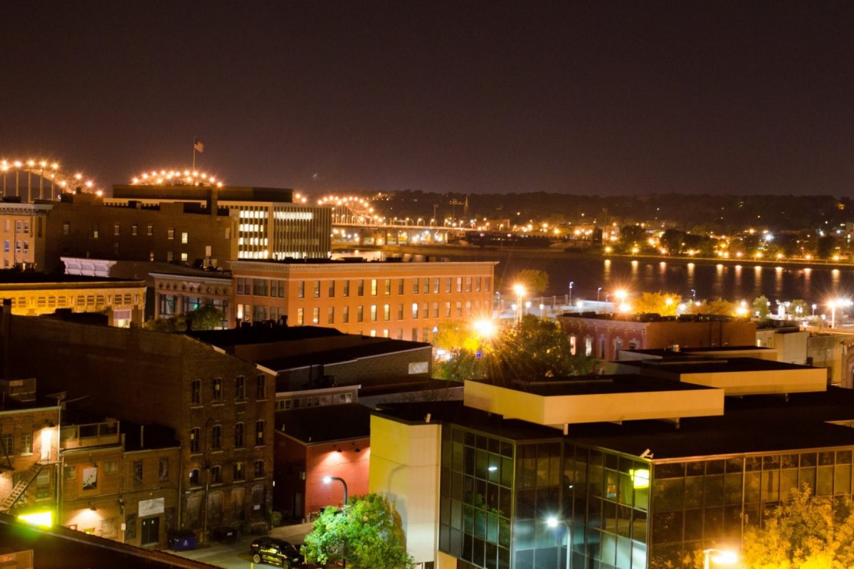 A cityscape illuminated by vibrant lights at night.