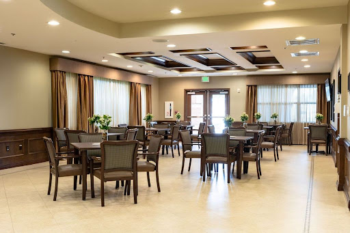 A spacious and well-lit dining area featuring modern furniture and a welcoming atmosphere.