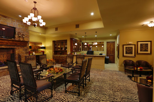 A cozy lounge area featuring comfortable seating, warm lighting, and a stylish zebra print carpet.