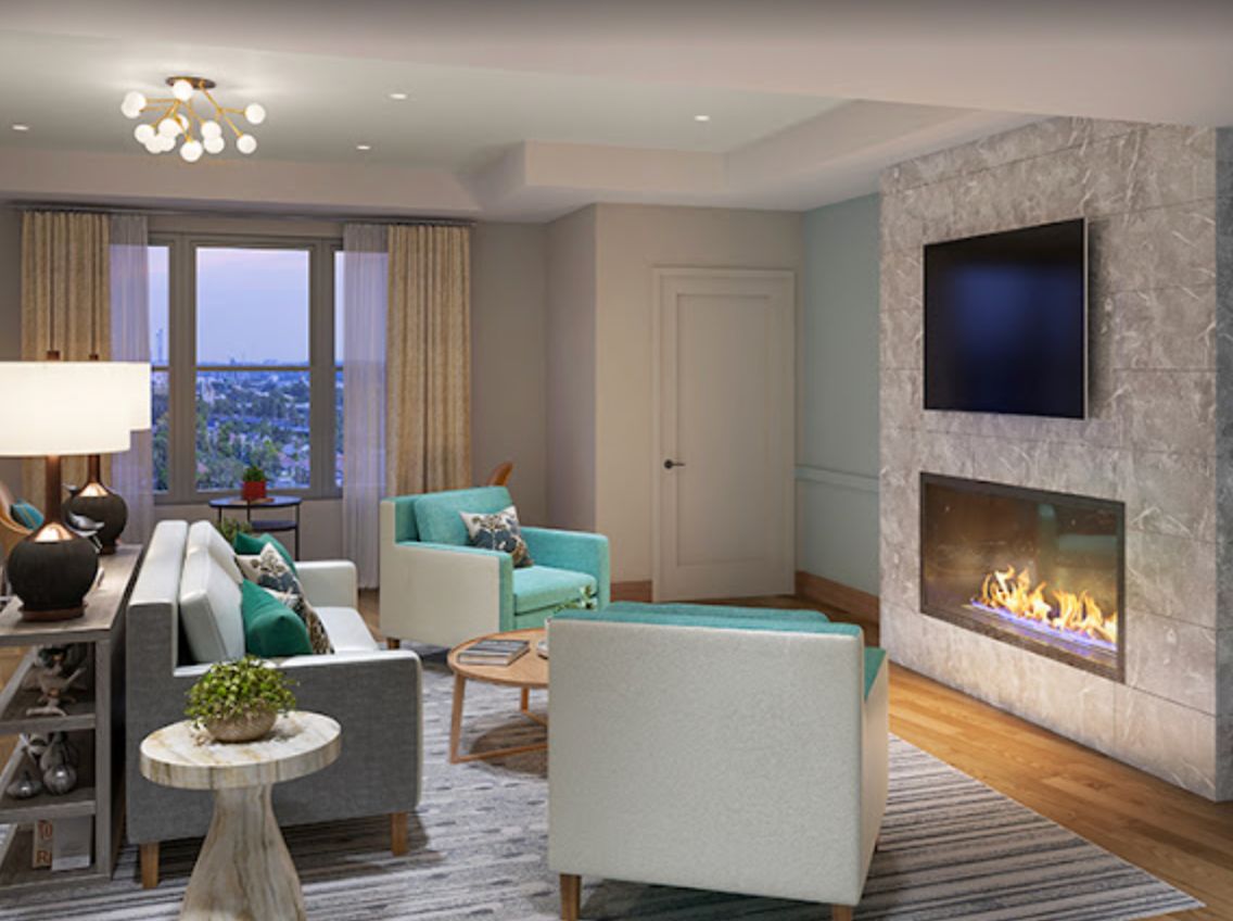 A modern living room featuring a cozy fireplace, stylish furniture, and large windows.