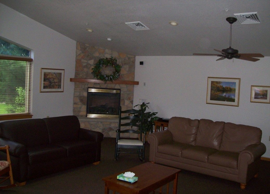 Cozy living room with sofas and a fireplace.