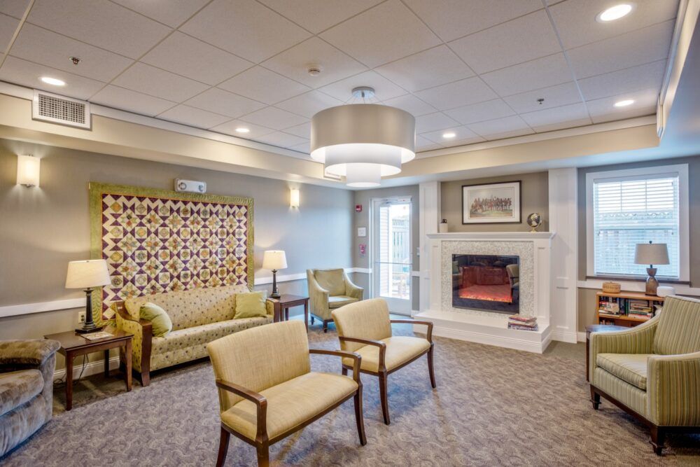 A cozy lounge area featuring comfortable seating and an elegant fireplace.