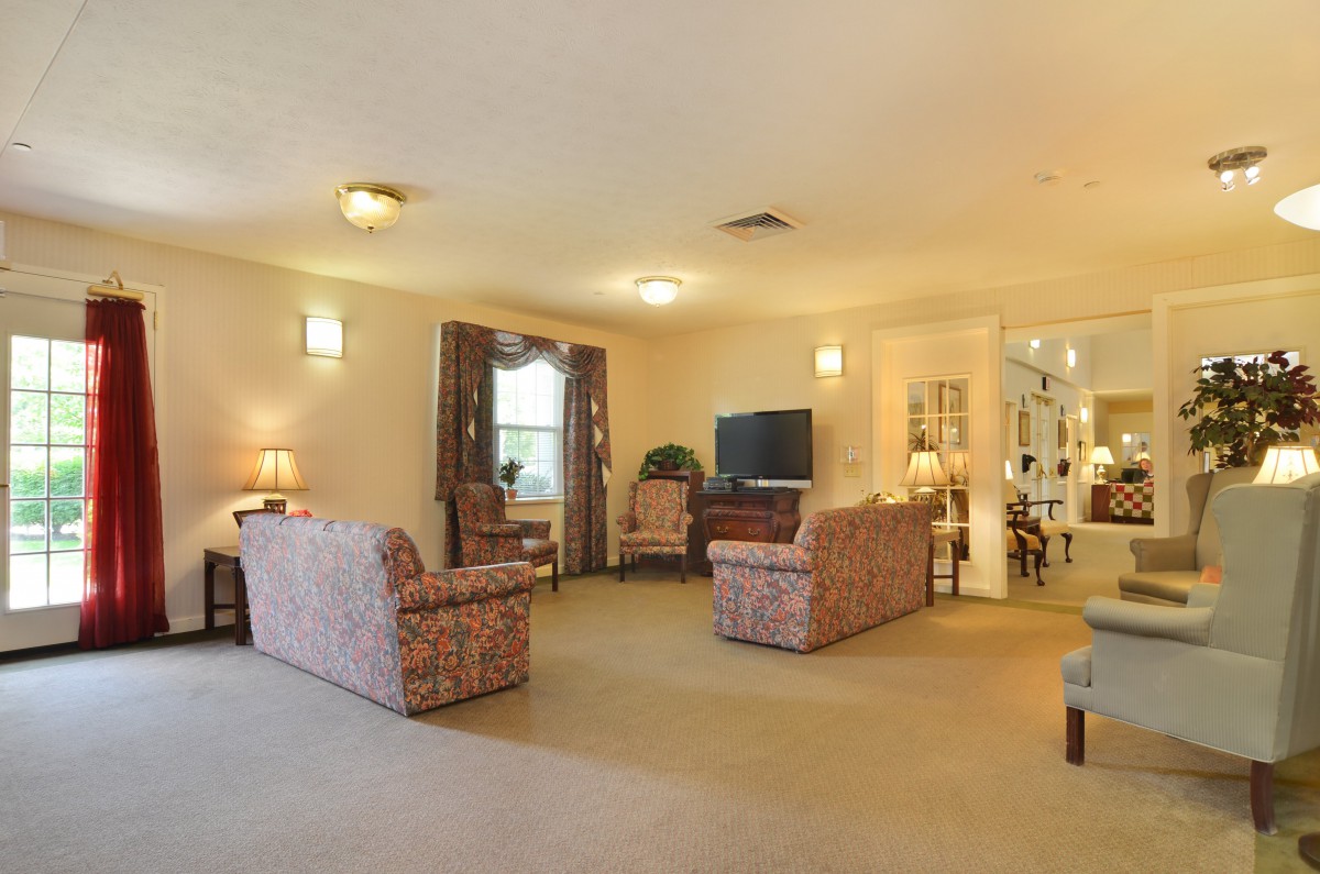 A spacious living room with comfortable seating and a television set.