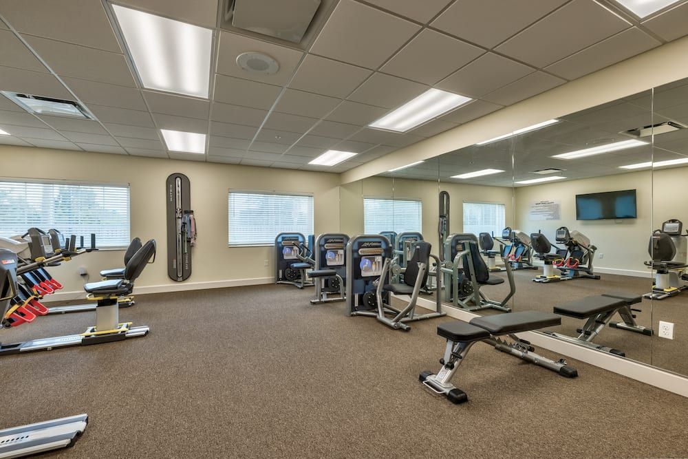 A well-equipped gym with various fitness machines and weights.