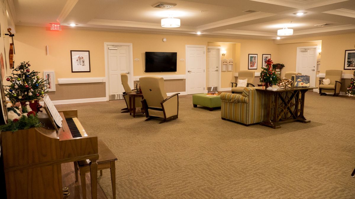 A spacious living room with comfortable seating and a large television.