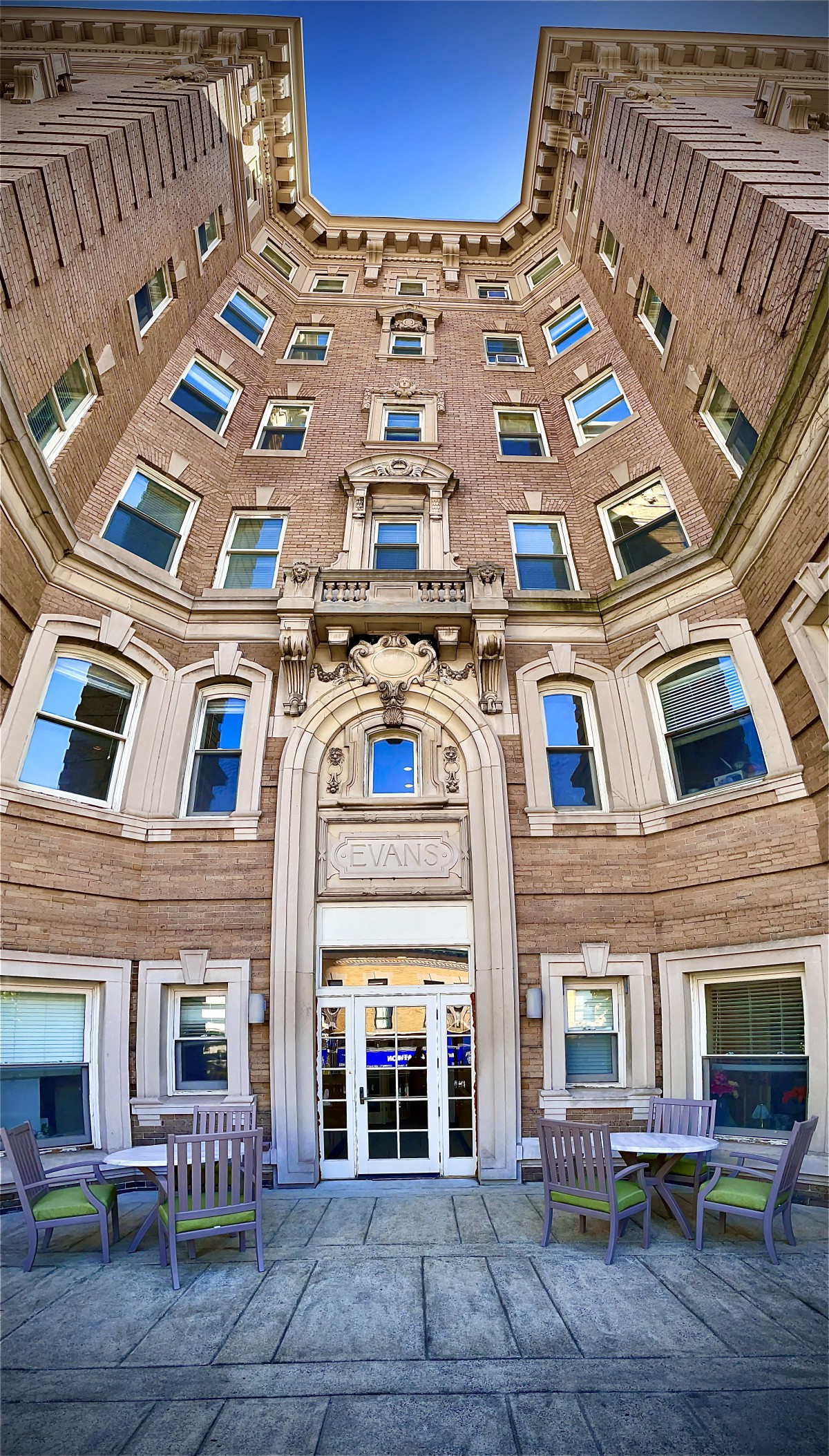 A low-angle view of a historic building's ornate facade with multiple windows.