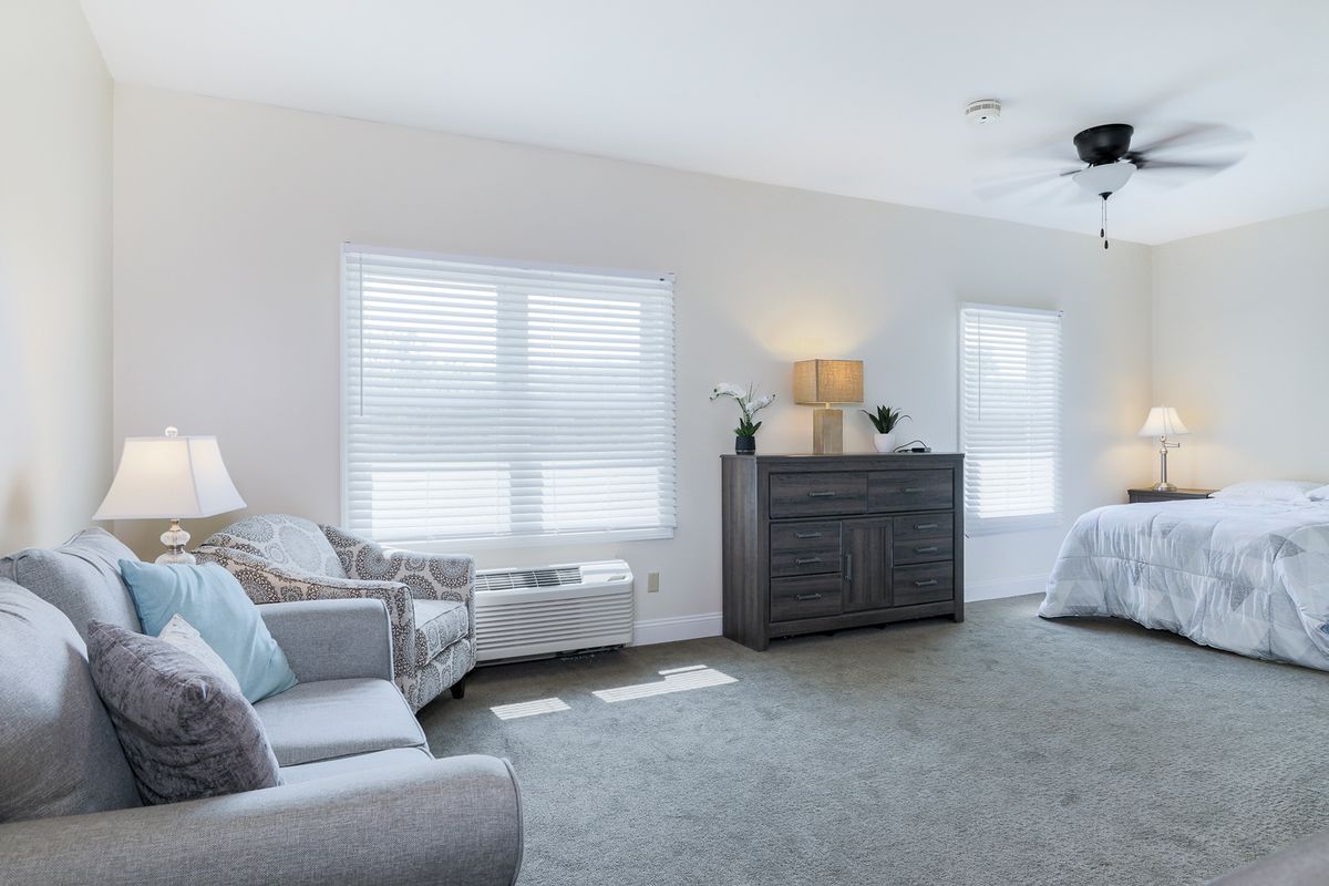 A bright and spacious living room with modern furniture and decor.