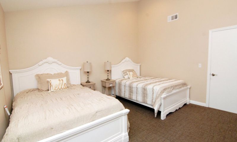 A cozy bedroom with two twin beds and matching nightstands.