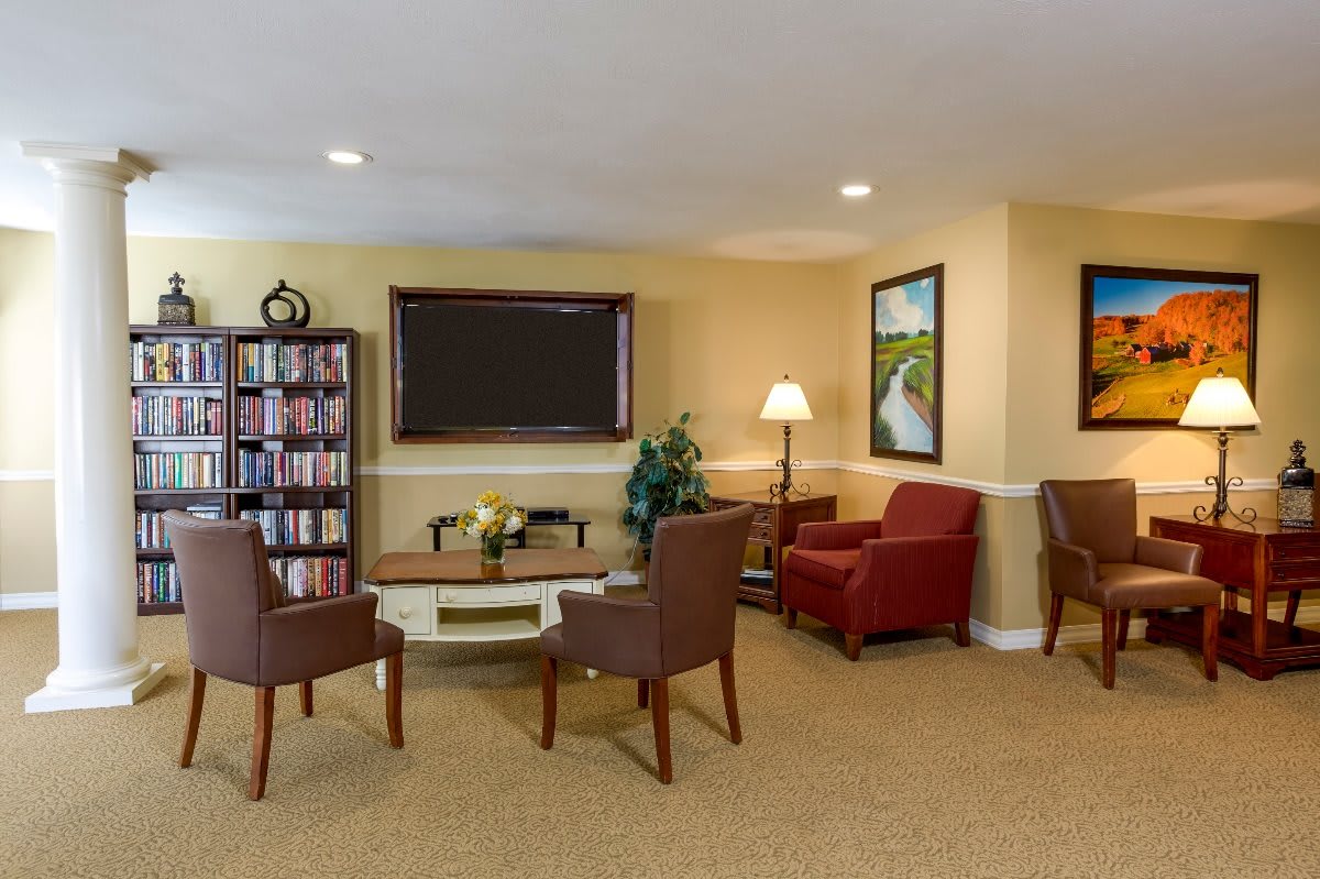 Cozy living room with a seating area and bookshelf.