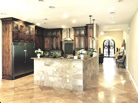 A spacious kitchen interior with a central island and wooden cabinets.
