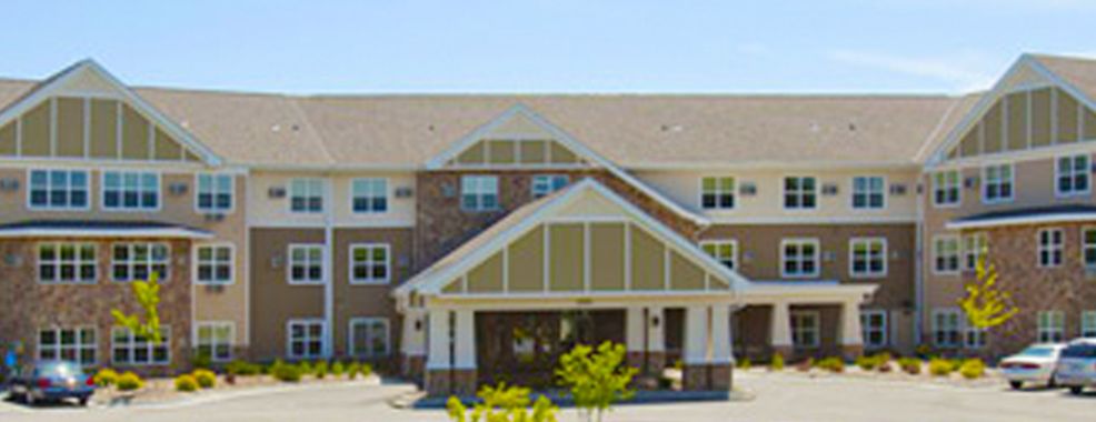 A residential building with a pitched roof and entrance canopy.