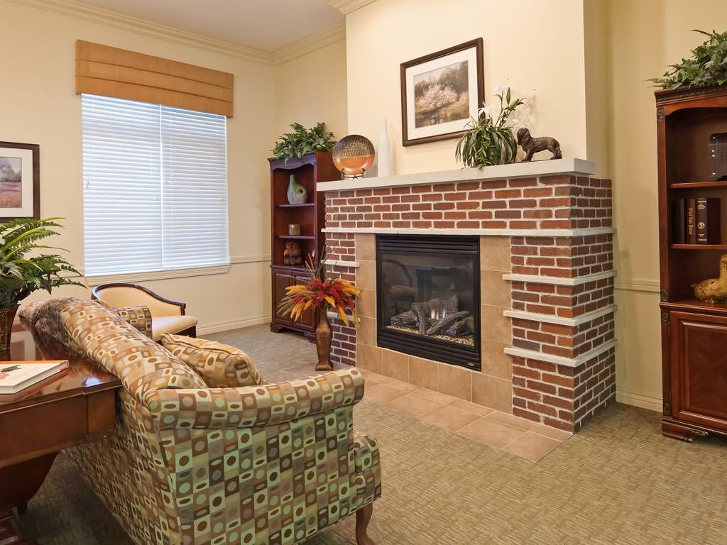 Cozy living room with a brick fireplace and comfortable seating.