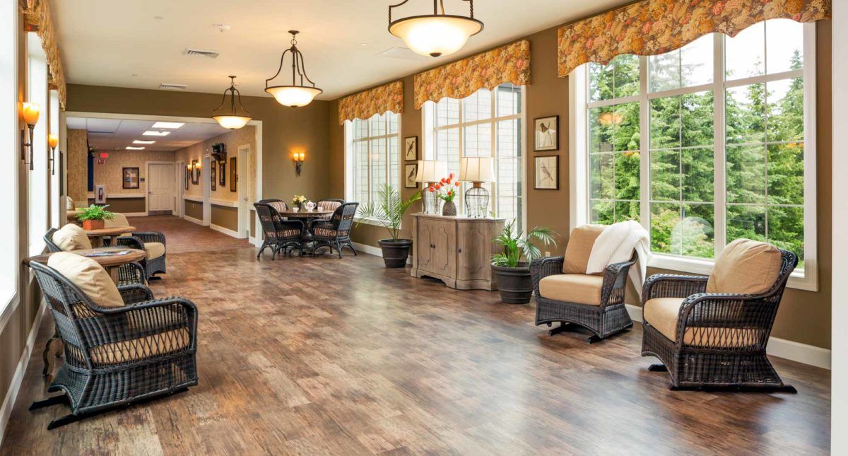 A spacious living room with large windows, comfortable seating, and elegant decor.