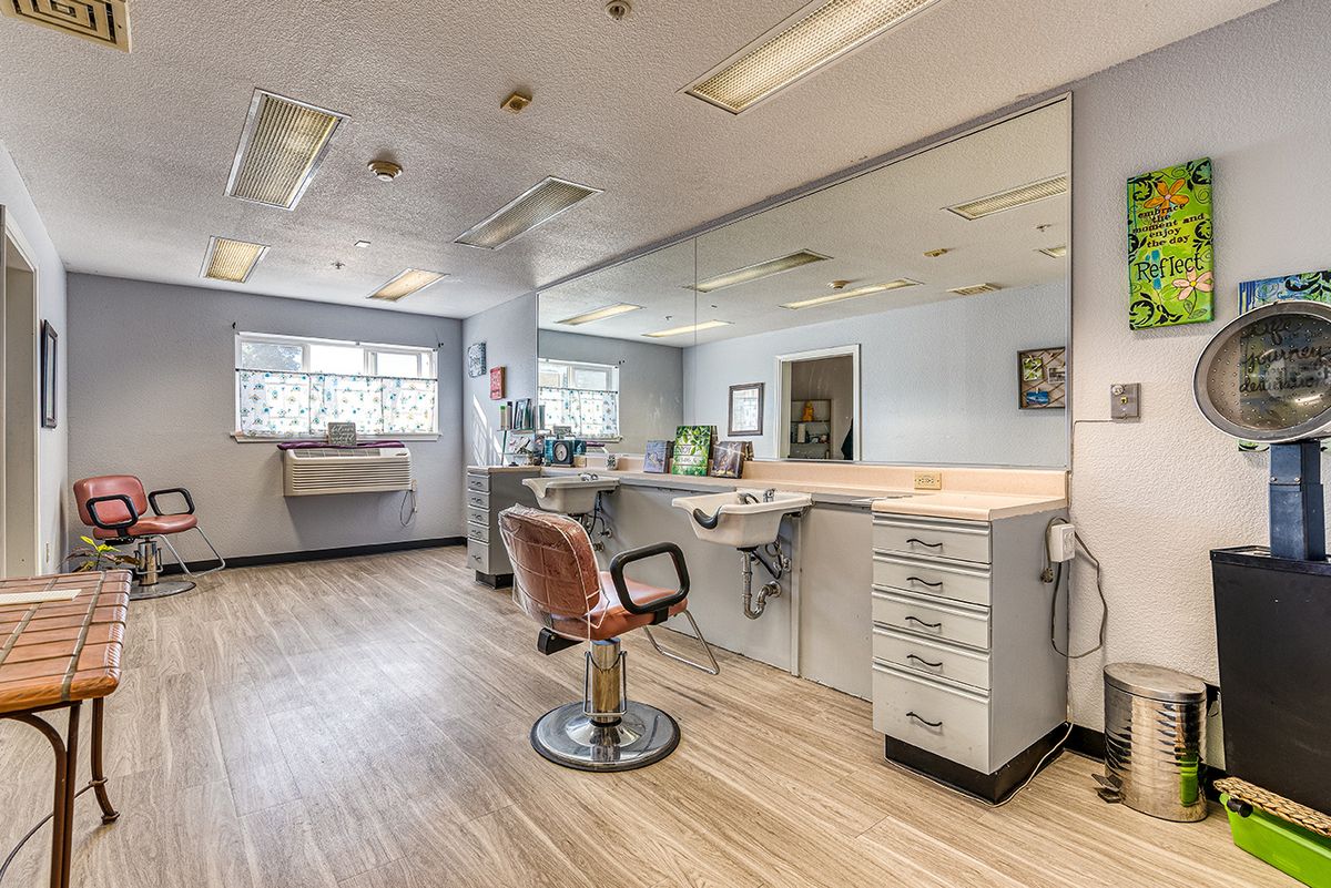 A modern and clean salon interior with styling chairs and mirrors.
