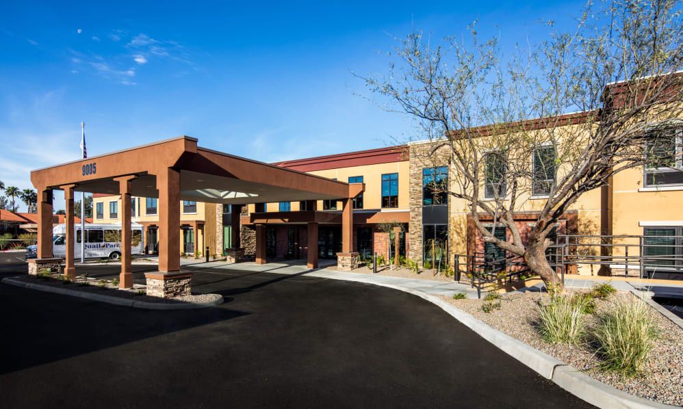 A modern commercial building with a welcoming entrance and landscaped surroundings.