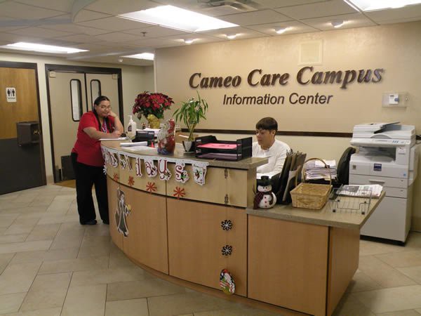 A reception area at the Cameo Care Campus, featuring an information desk with staff members.