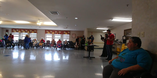 A lively community event taking place indoors, featuring a performance in front of an engaged audience.
