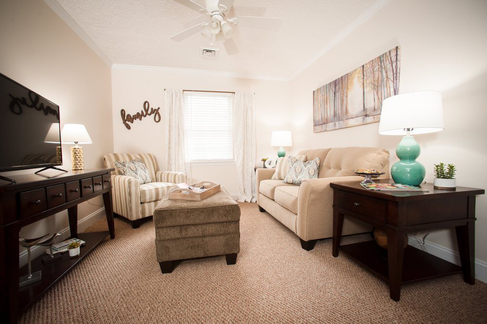 A cozy living room with comfortable seating and warm lighting.