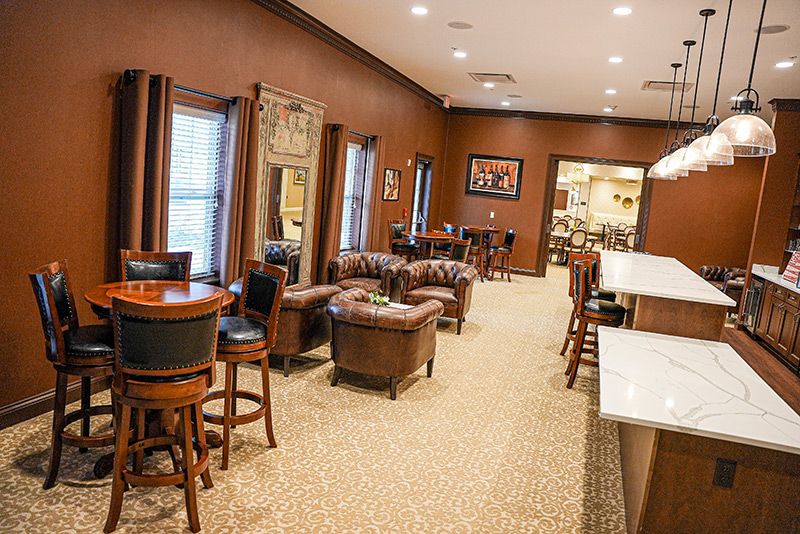 A cozy lounge area with comfortable seating and a bar.