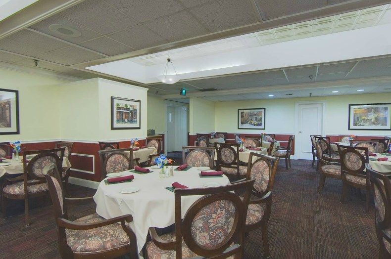 An elegant dining area in a restaurant with neatly arranged tables and chairs.