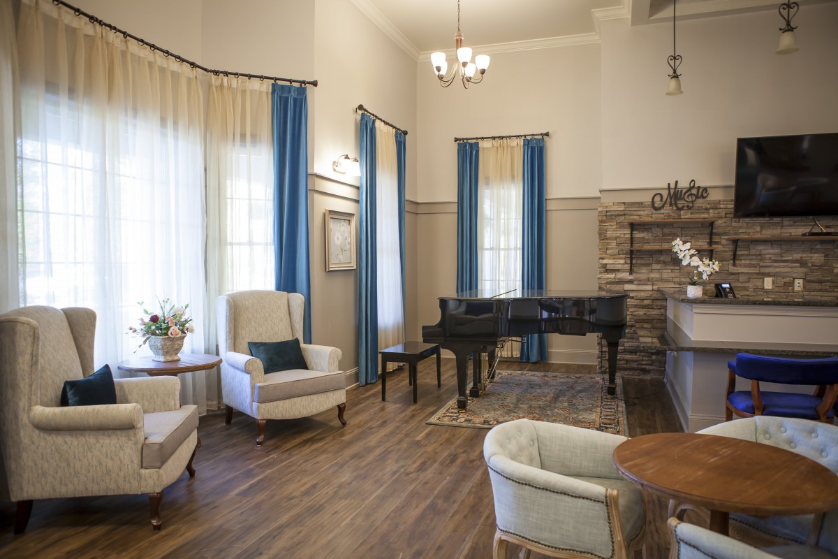 An elegant living room featuring a grand piano and classic decor.