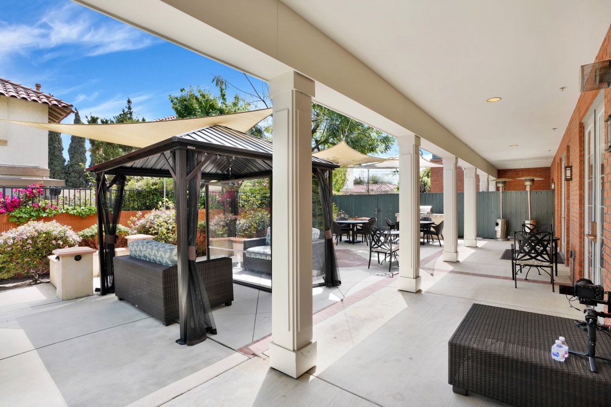 A spacious outdoor patio with comfortable seating and a gazebo, perfect for relaxation.
