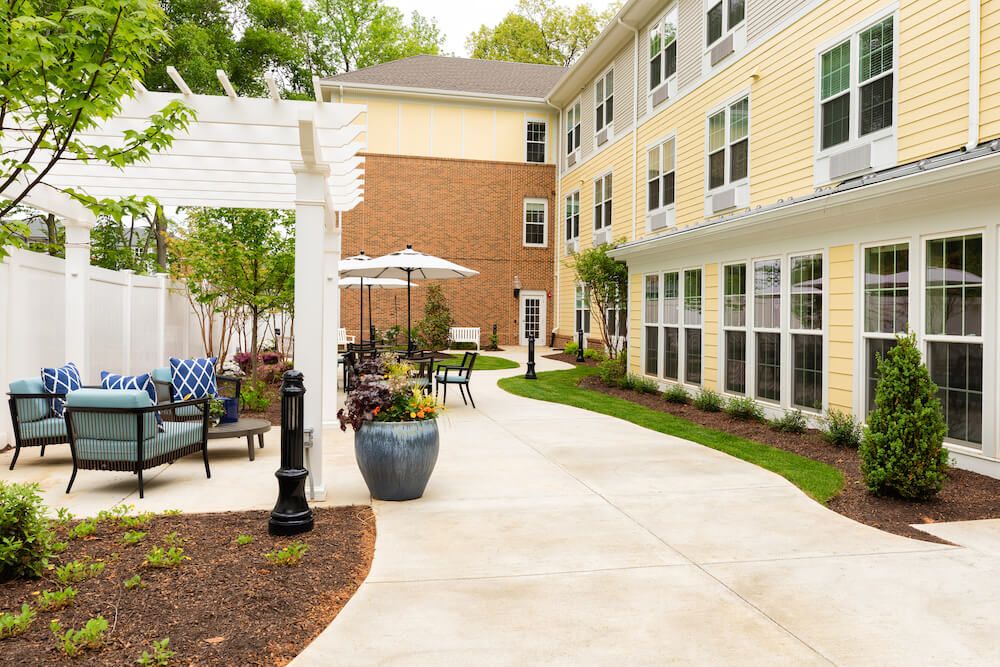 A well-maintained outdoor patio area with seating next to a multi-story building.