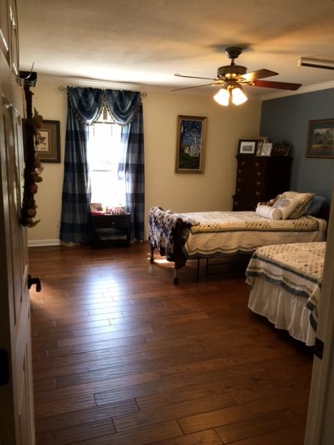 A cozy bedroom featuring twin beds and traditional decor.
