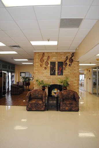 A cozy lobby area featuring comfortable seating and music-themed decorations.