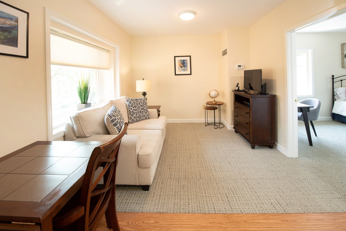 A cozy living room with a beige couch, TV, and stylish decor.